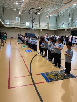Photo of students praying in the gym
